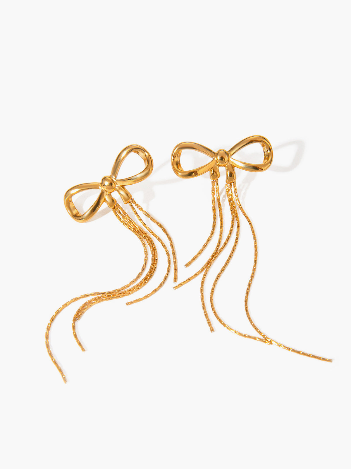 Earring hoops with a shiny gold bow design
