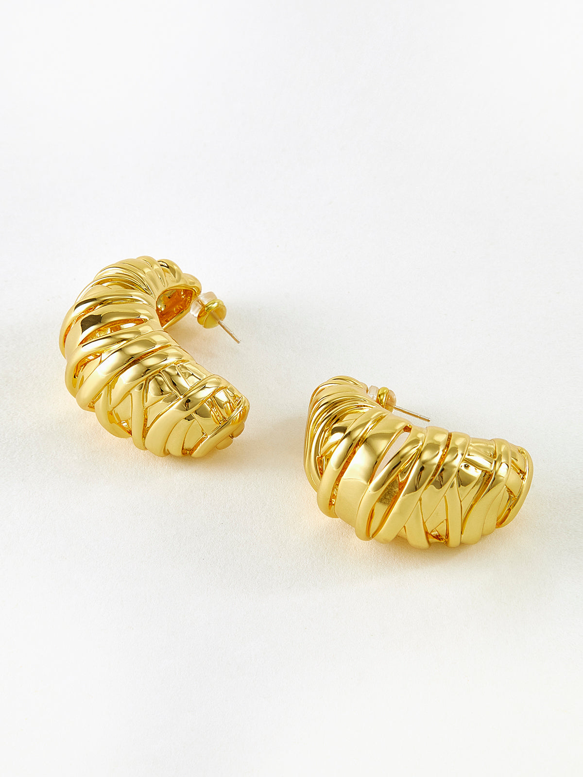 Elegant twisted half-moon gold-colored earrings