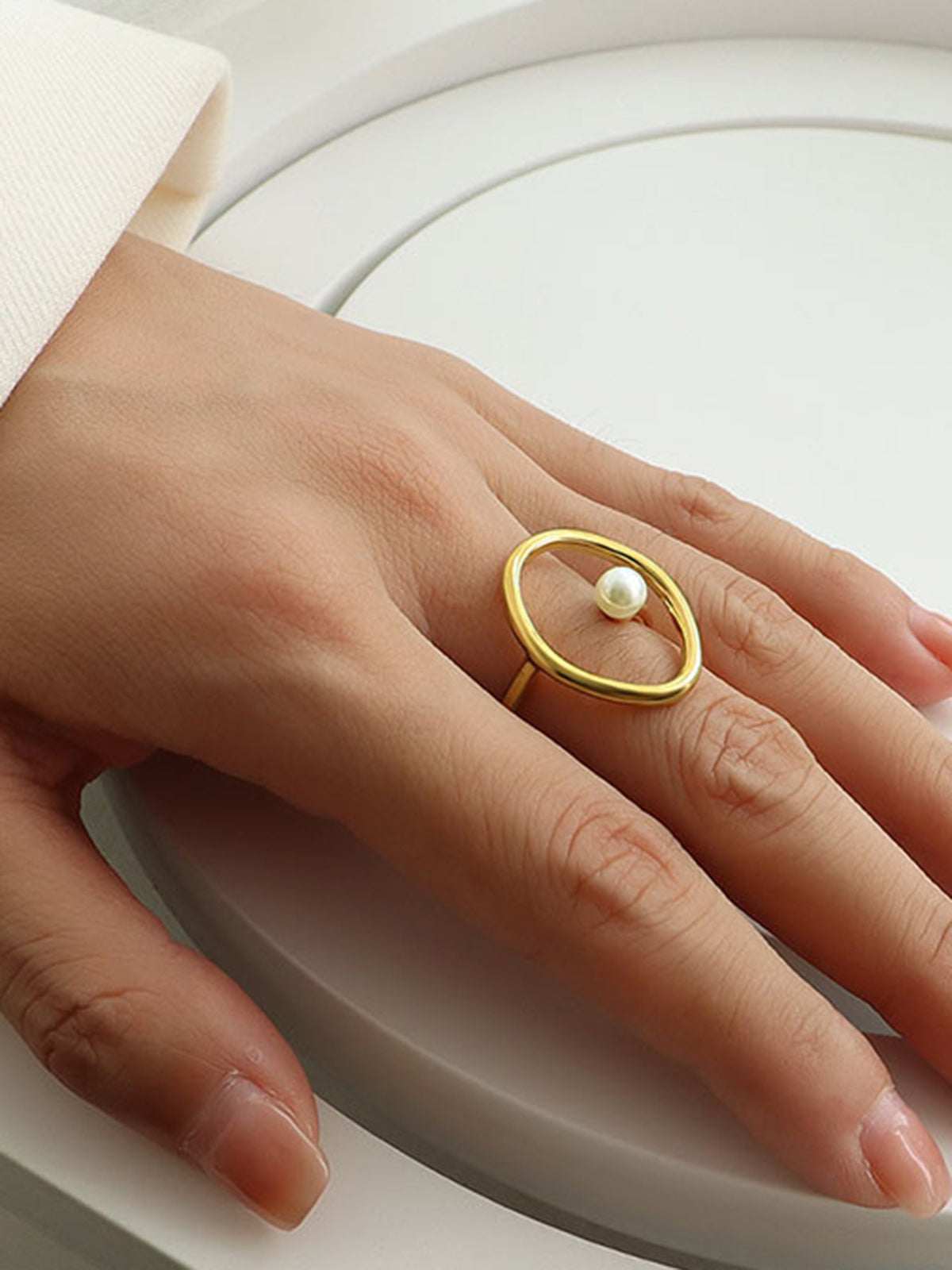 Gold ring with freshwater pearl in oval and circular shapes for an elegant look