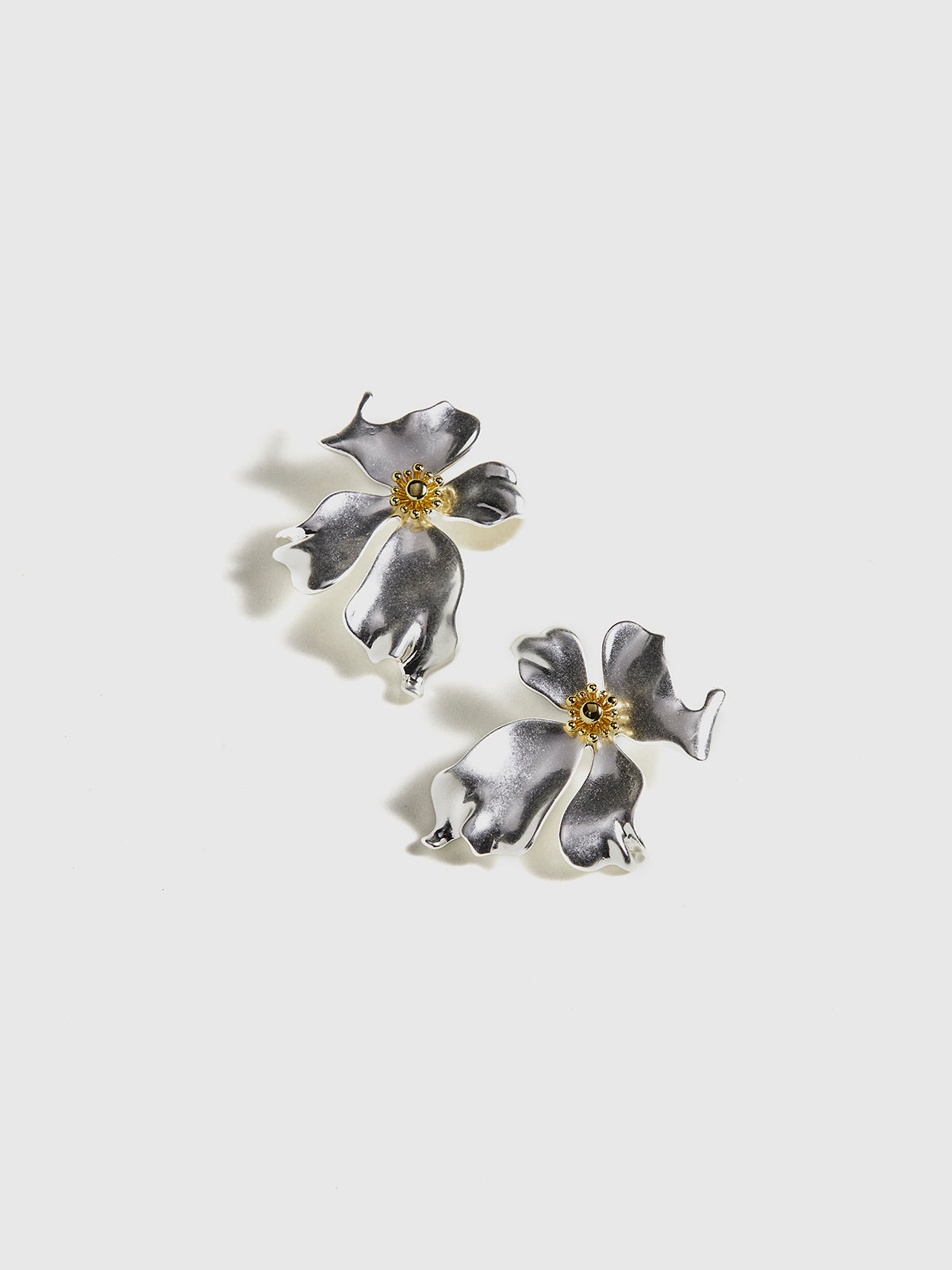 Elegant metal jewelry with unmatched features and a flower petal – striking push-up earrings