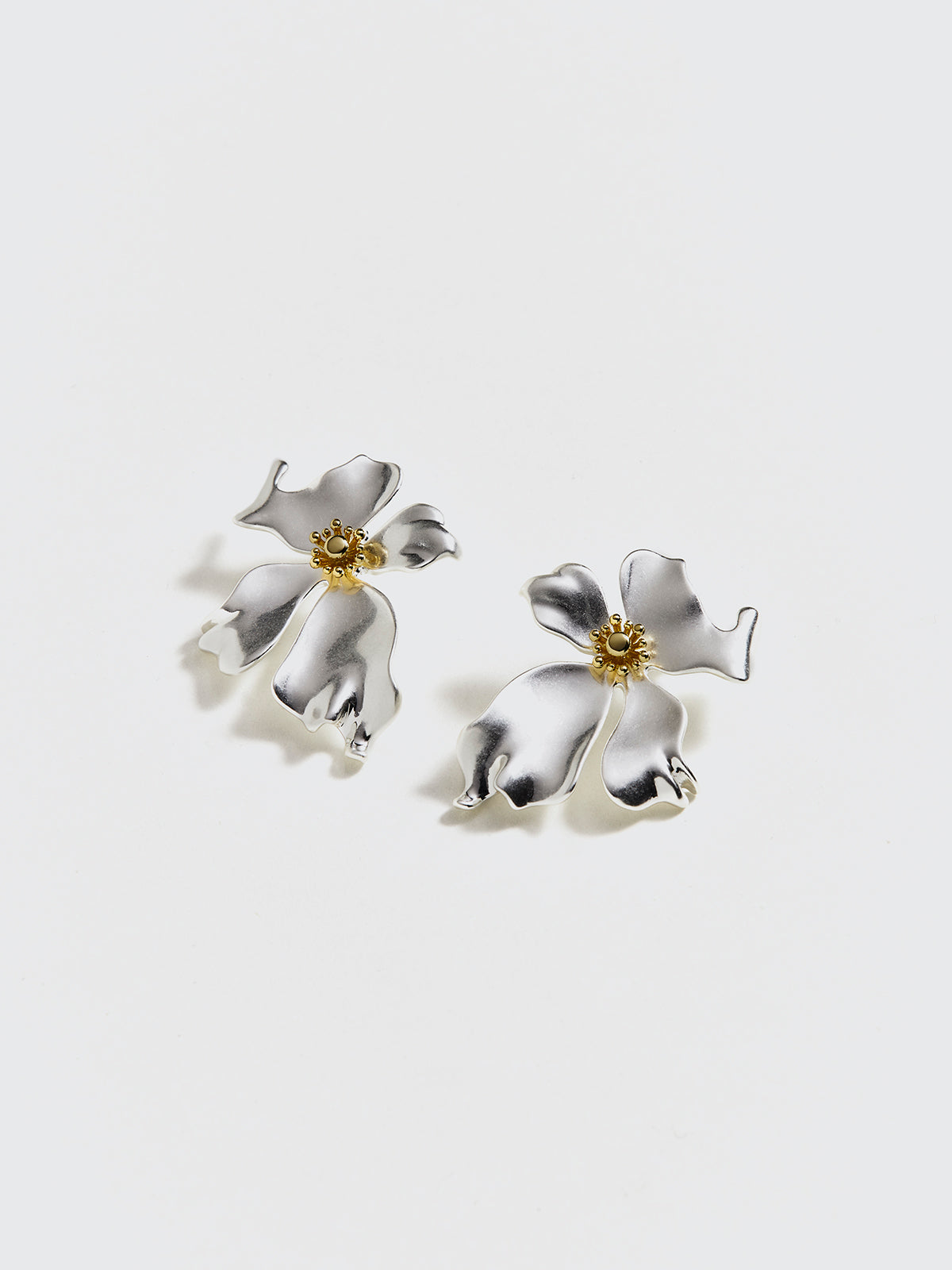 Elegant metal jewelry with unmatched features and a flower petal – striking push-up earrings