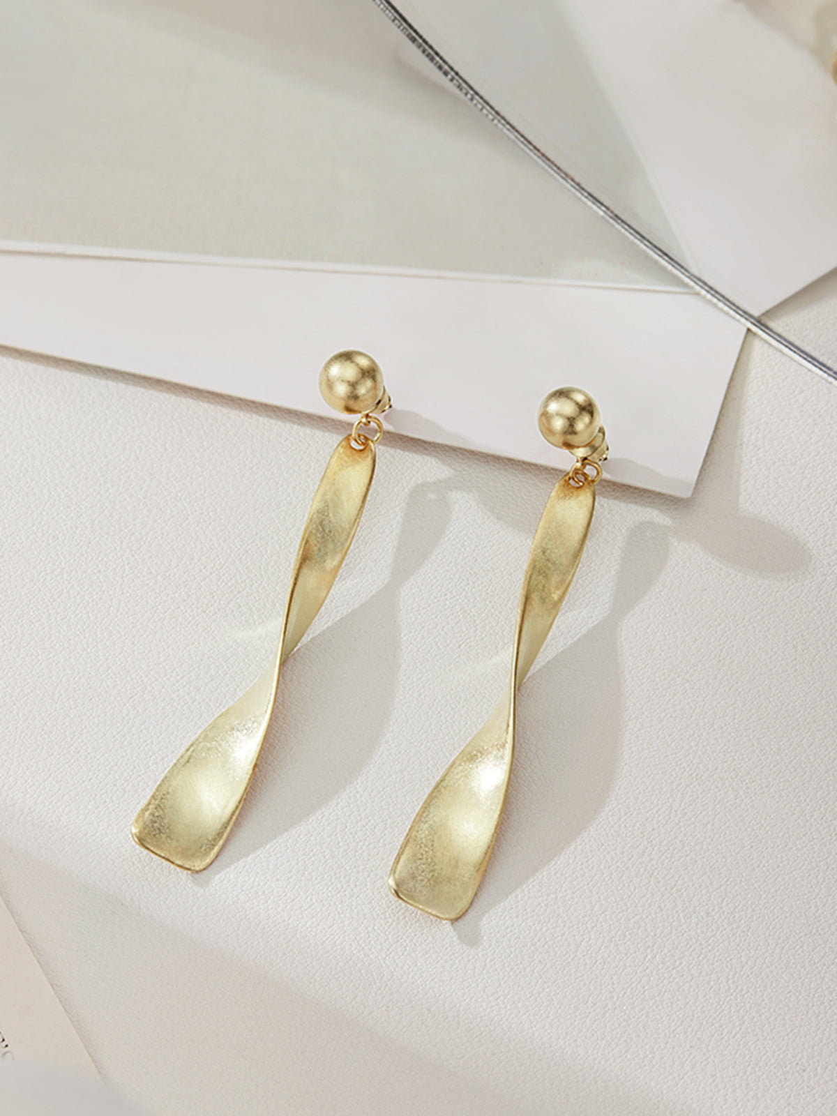 Vintage metal hoop earrings with spiral design