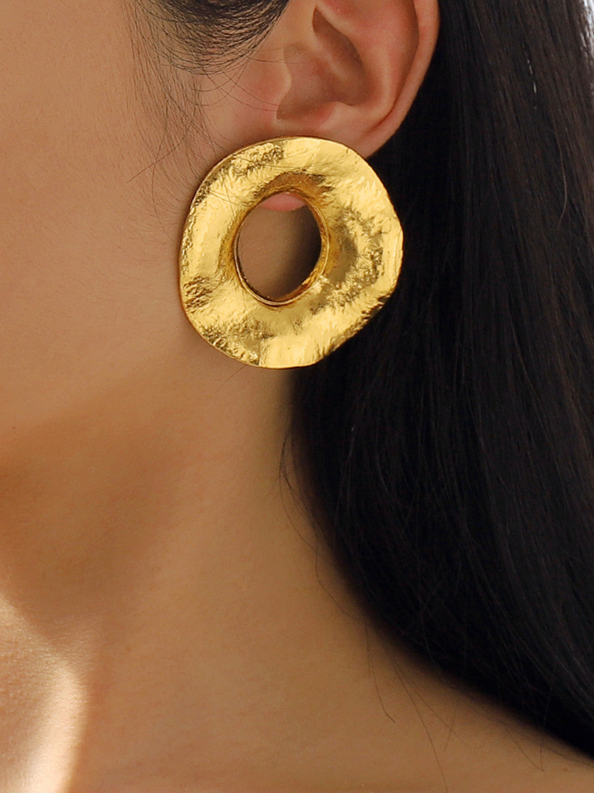 Round gold-colored metal earrings with texture for an elegant look