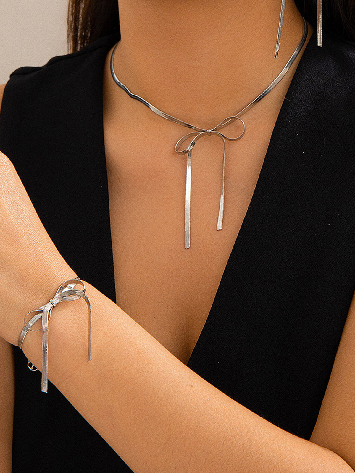 Complete your style with the elegant bow and tassels necklace and bracelet set